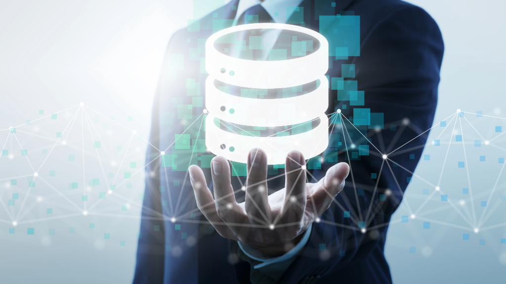 The image shows a hand holding a digital data structure, symbolizing GENESYS's centralization of system and design data, enabling real-time access and minimizing conflicts.