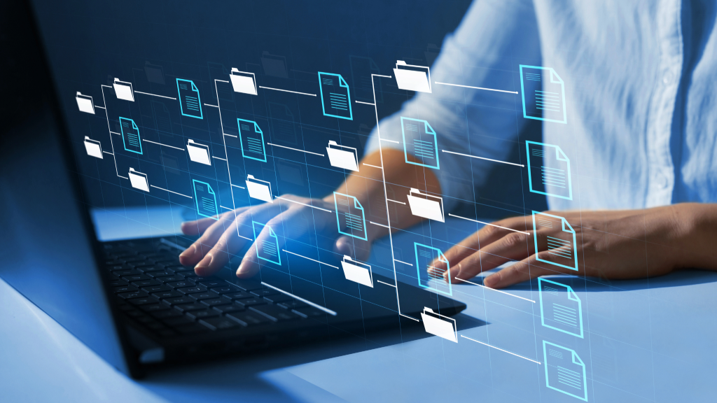 Typing with floating folder icons, symbolizing how GENESYS integrates and updates industry standards into the project model to ensure ongoing compliance.