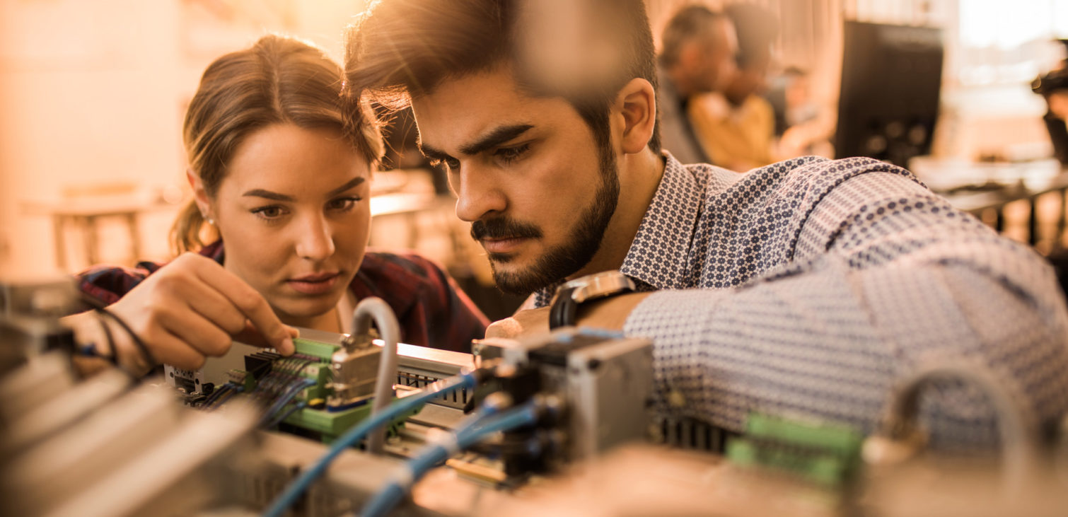 Two-engineering-students-working-on-electrical-component-of-a-machine-in-laboratory-1510x731