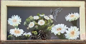 Picture of a reverse glass paining with white flowers and a bat