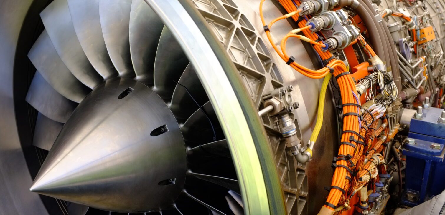 close-up image of airplane engine, showing the wire harnesses.